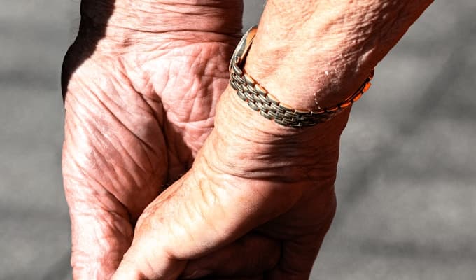 Elderly couple holding hands
