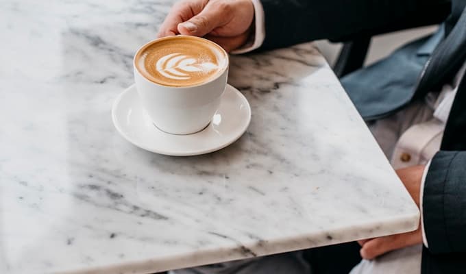 Man sitting peacefully at a cafe with coffee