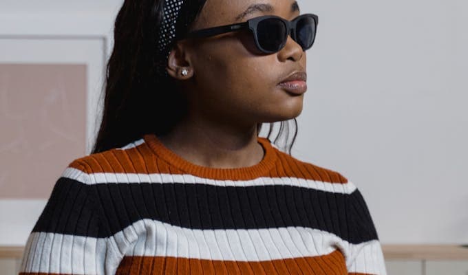 Woman with dark sunglasses, visually impaired
